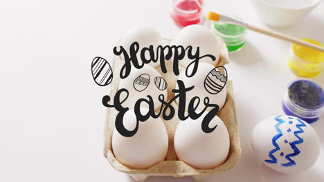 Animation-of-happy-easter-text-over-eggs-and-paints-on-white-background