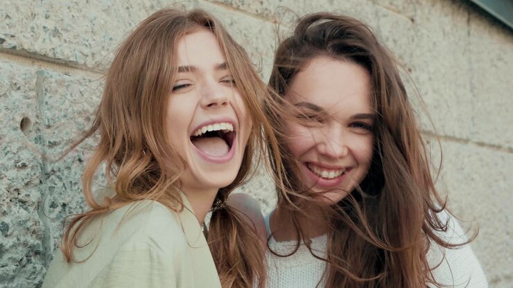 Two friends laughing outdoors