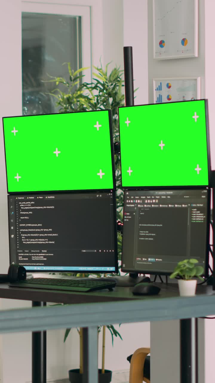 Vertical video: Asian system engineer using html script code and greenscreen on multiple monitors