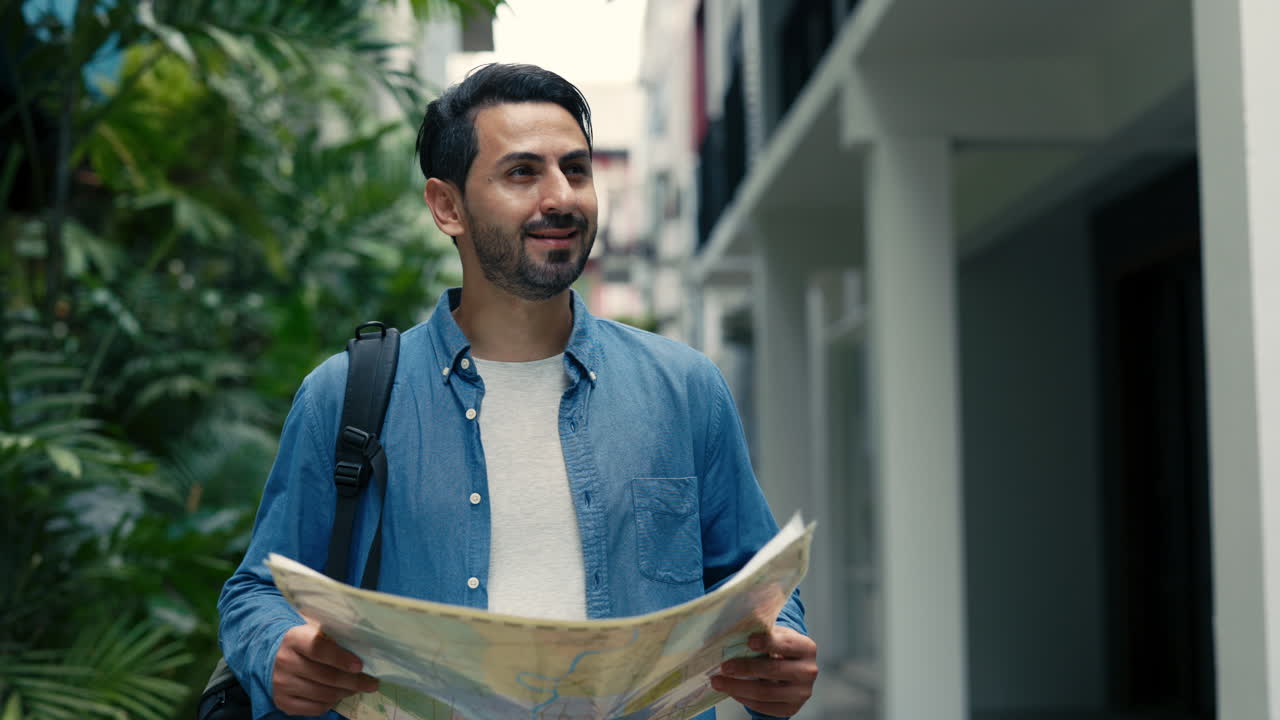 Smiling Man Looking at Map While Exploring City