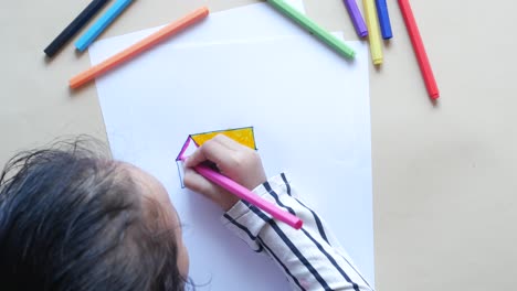 Child-girl-drawing-on-paper-sitting-on-floor