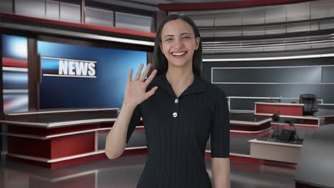 Happy-Indian-female-news-anchor-saying-Hello