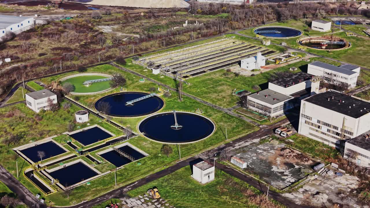Water treatment facility located near a city with various processing tanks