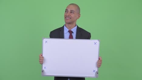 happy handsome bald multi ethnic businessman with whiteboard