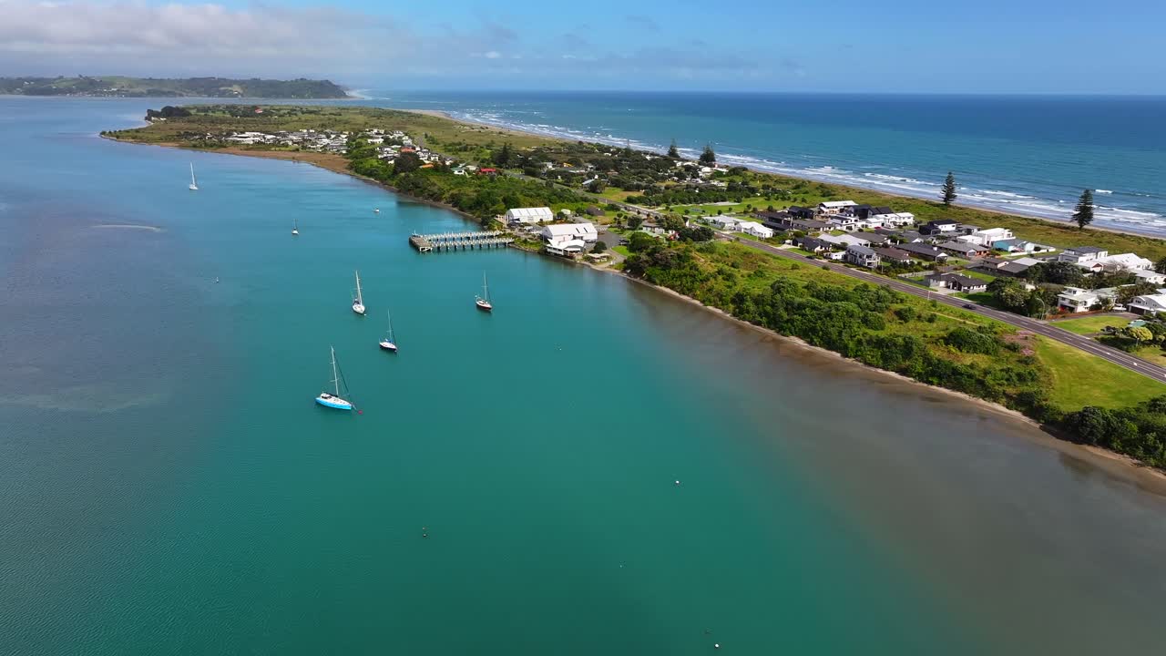 Boats sit in a quiet harbour, the glassy water calm as boats bob nearby and sunlight dances on the gentle ripples around them. touring hobby