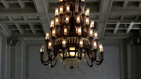 vintage crystal chandelier over the ceiling of an old ministry of treasure building in rio de janeiro, brazil