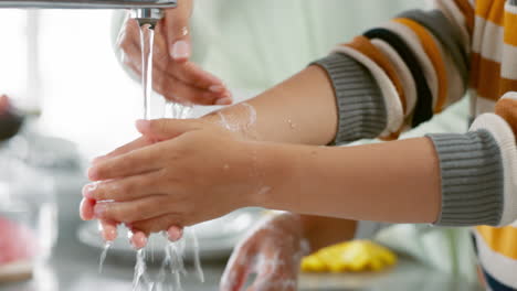 kid, washing and hands with mom in closeup