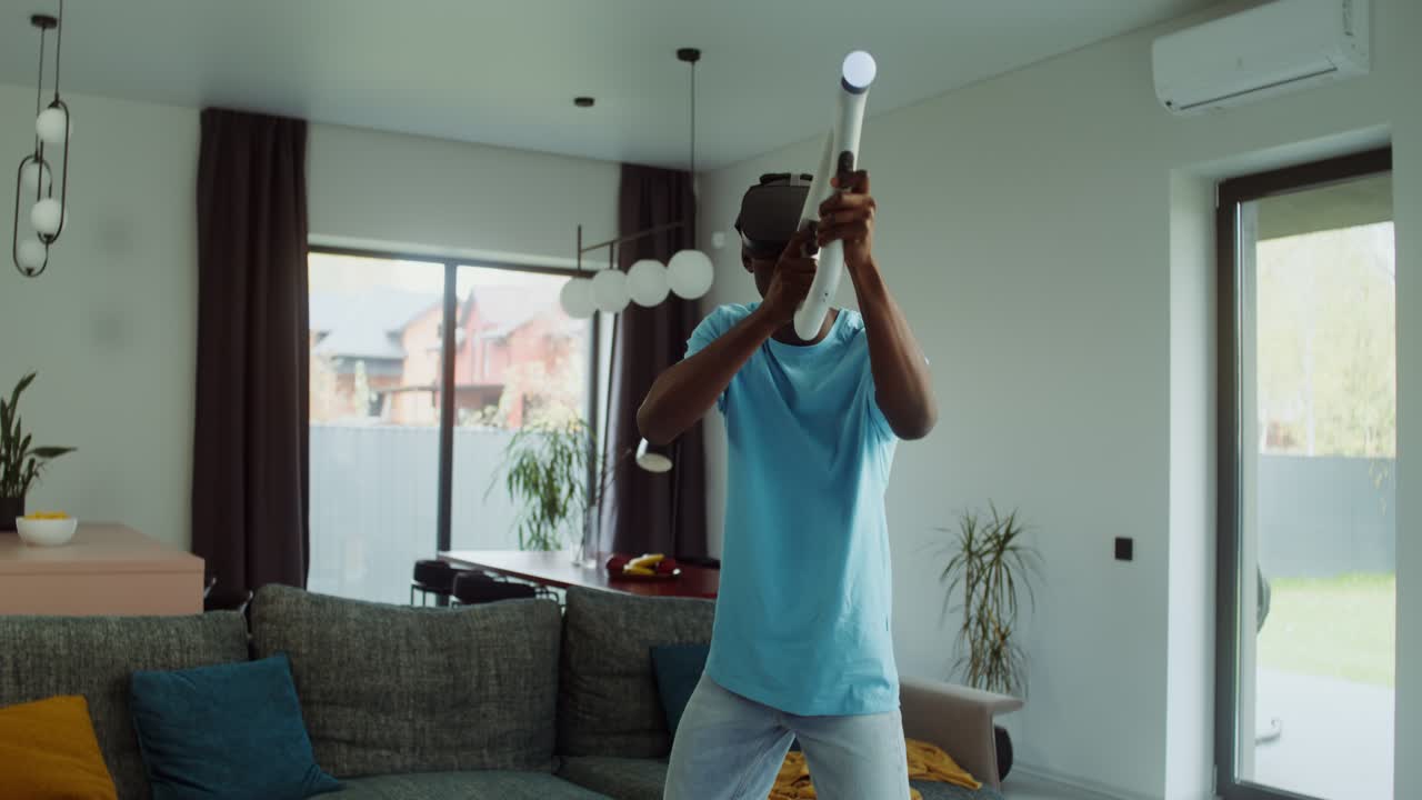 Man playing virtual reality game at home