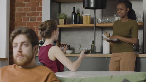 two  roommates talking and spending time together in the kitchen