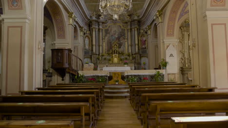 an inside tilting up of view of an empty catholic church, having beautiful and antique art work