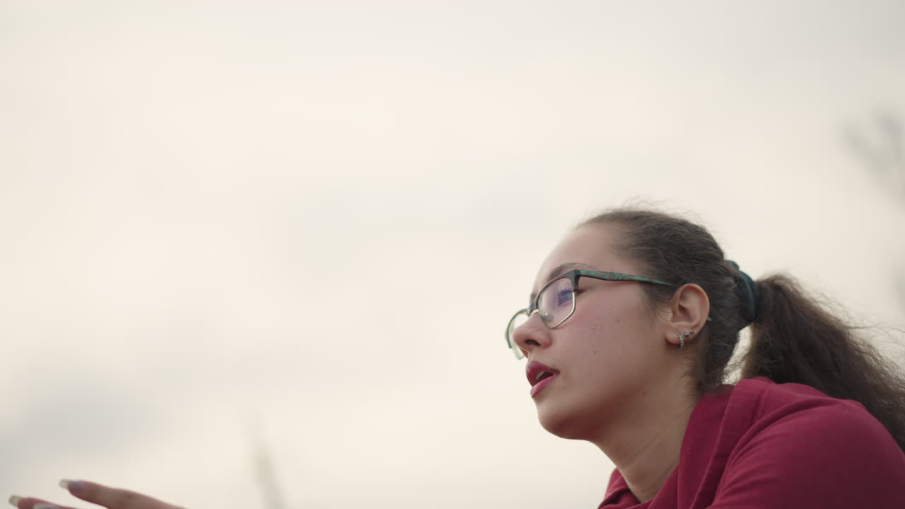 Woman Warms Up Voice Outdoors, Young Lady Practices Breath And Singing Exercises Outside, Enthusiastic Young Woman Dedicated To Vocal Warmup And Breathing Exercises In Outdoor Park Setting