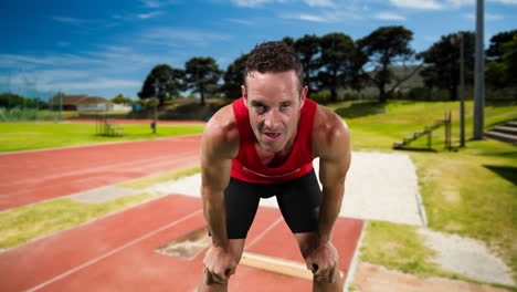 male athlete against sports field in background