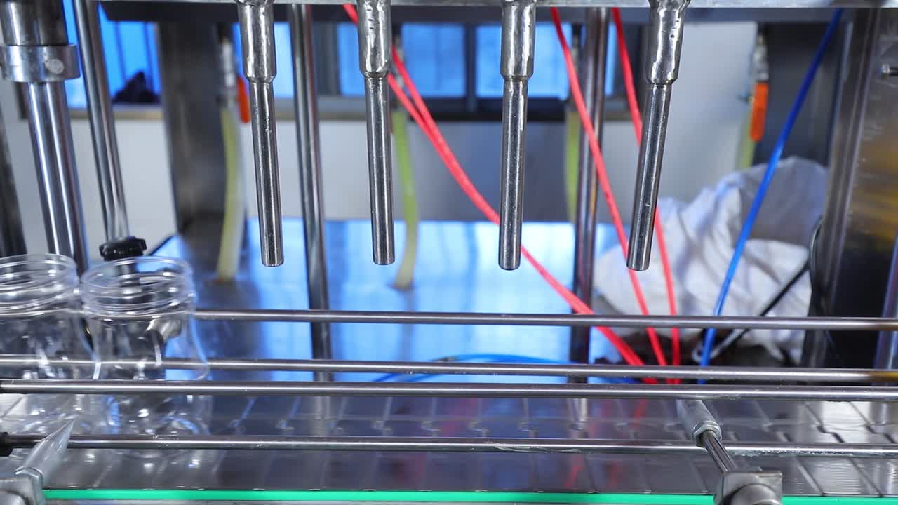 Beverage factory, Conveyor belt with juice in bottles, Industrial Interior in blue color, food and drink production line process