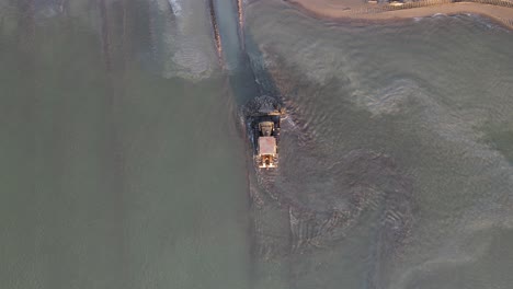 bulldozer working the beach