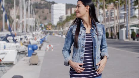 casual woman enjoying a walk through a marina