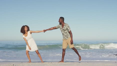 african american couple enjoying seaside