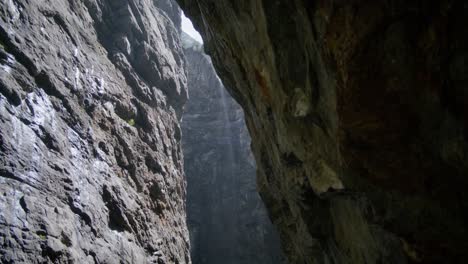 looking up from dark part of cave to bright mountainside rocks | grindelwald switzerland cave in glacier canyon, europe, 4k