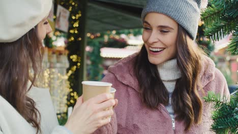 handheld view of friends having hot coffee outdoors