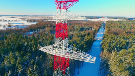 electric towers in winter forest. transmission tower aerial view. electricity