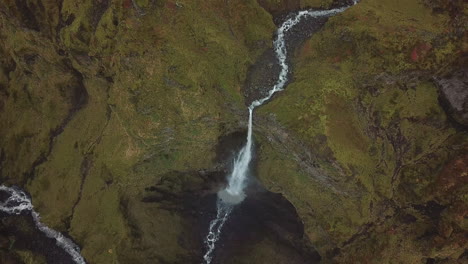 Dramatic-Aerial-View-on-Glacial-Water-Falls-Into-Deep-Canyon-in-Highlands-of-Iceland
