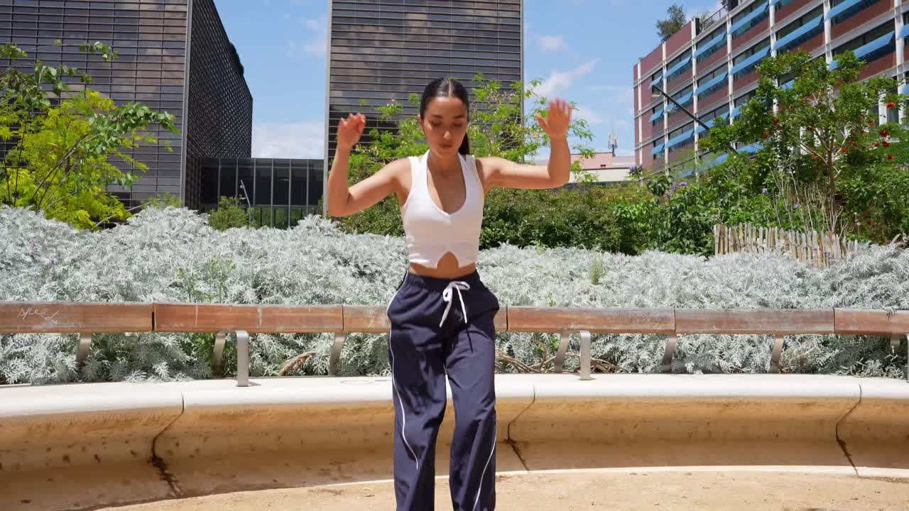 Woman dancing in an urban park