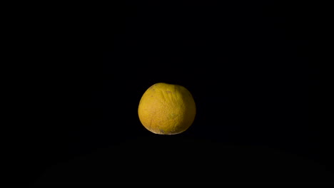 whole and ripe orange isolated on black background