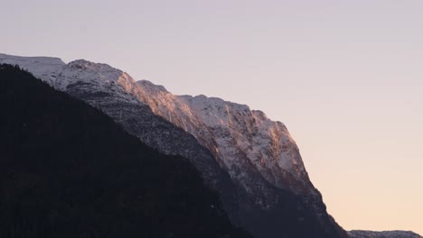 Dusk-sunset-and-strong-wind-over-snowy-peak-mountain---Time-Lapse