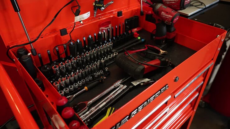 Car repairman clean toolbox workshop, panning shot