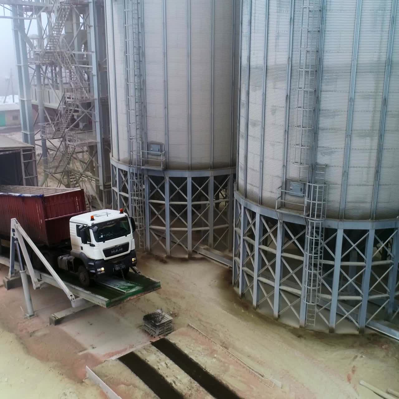 Steel huge wheat grain elevator. Aerial view of big metal storage construction