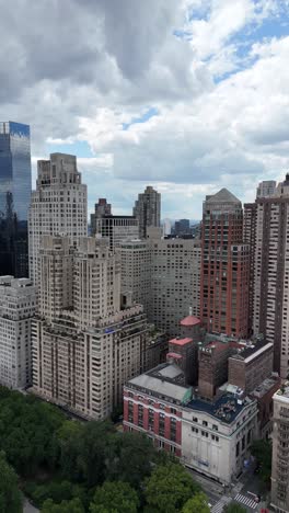 vertical push-in drone shot of upper west side nyc with central park in the foreground, highlighting the mix of urban skyline and natural green space