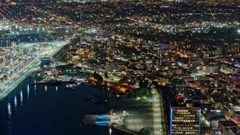 Vancouver-BC-Canada-Aerial-v4-hyperlapse-zoomed-shot-of-Centerm-container-terminal-on-the-Eastside,-panning-reveal-harbor-views-and-downtown-night-cityscape---Shot-with-Mavic-3-Pro-Cine---July-2023