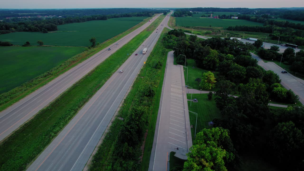Evening Traffic on I-90 Near Milton, Wisconsin. Dry Van Truck Driver on Interstate next to Rest Area