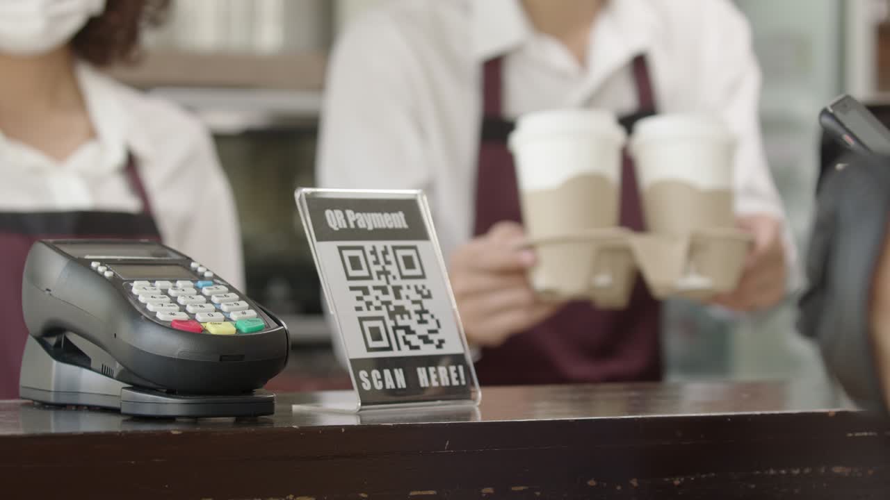 Woman use smartphone to scan and pay for take away coffee | Premium ...