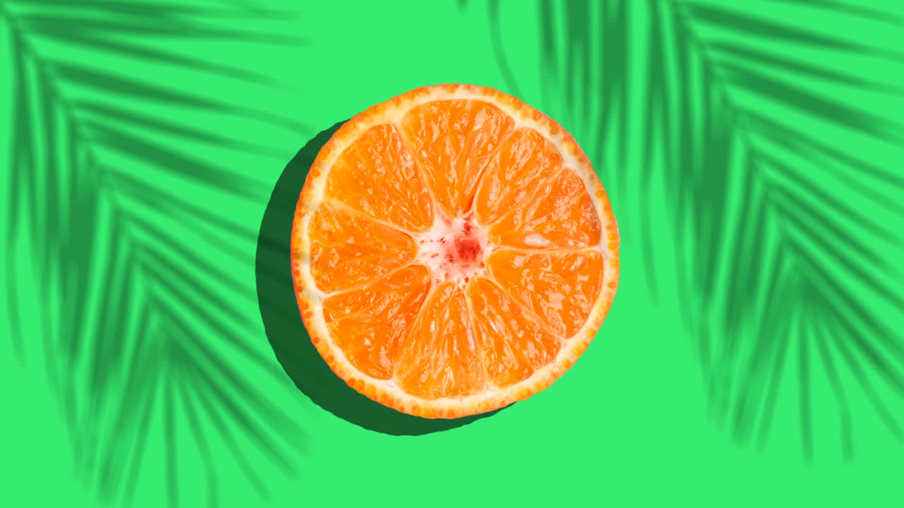 naranja girar en la luz del sol con sombras de palma en un fondo azul de color. jugos de frutas, relajación, trópicos y concepto de relajación.
