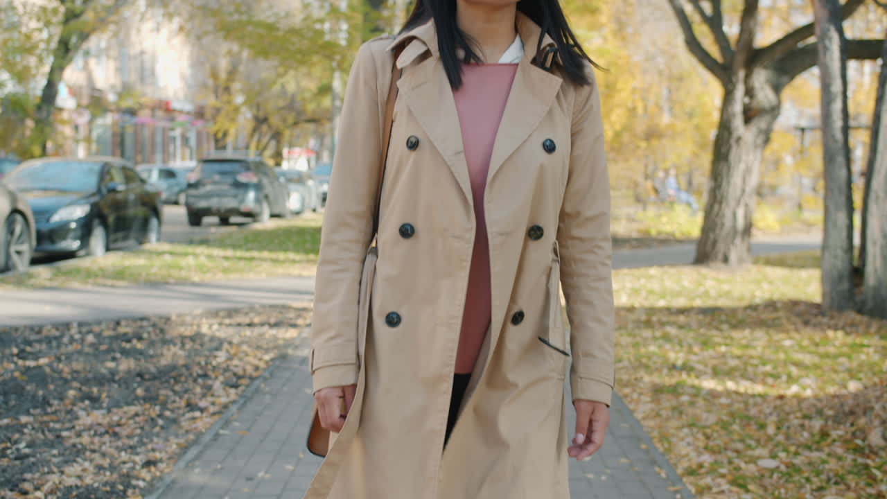 Woman Walking in an Autumn Park