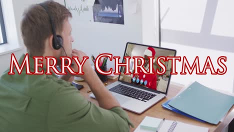 Animation-of-merry-christmas-text-over-caucasian-man-with-headset-on-laptop-video-call-with-family