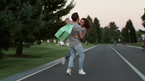 Couple-in-love-having-fun-in-summer-park-after-successful-shopping