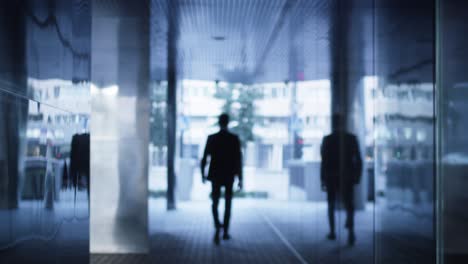 businessman walking on streets of business district outwards camera
