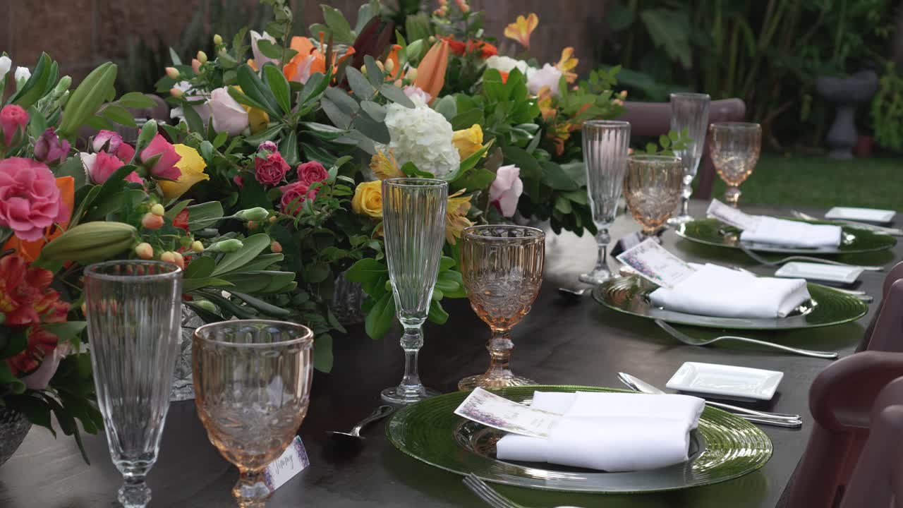 Crystal glasses placed on the wedding banquet table along with elegant tableware