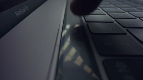 man using touch bar on laptop