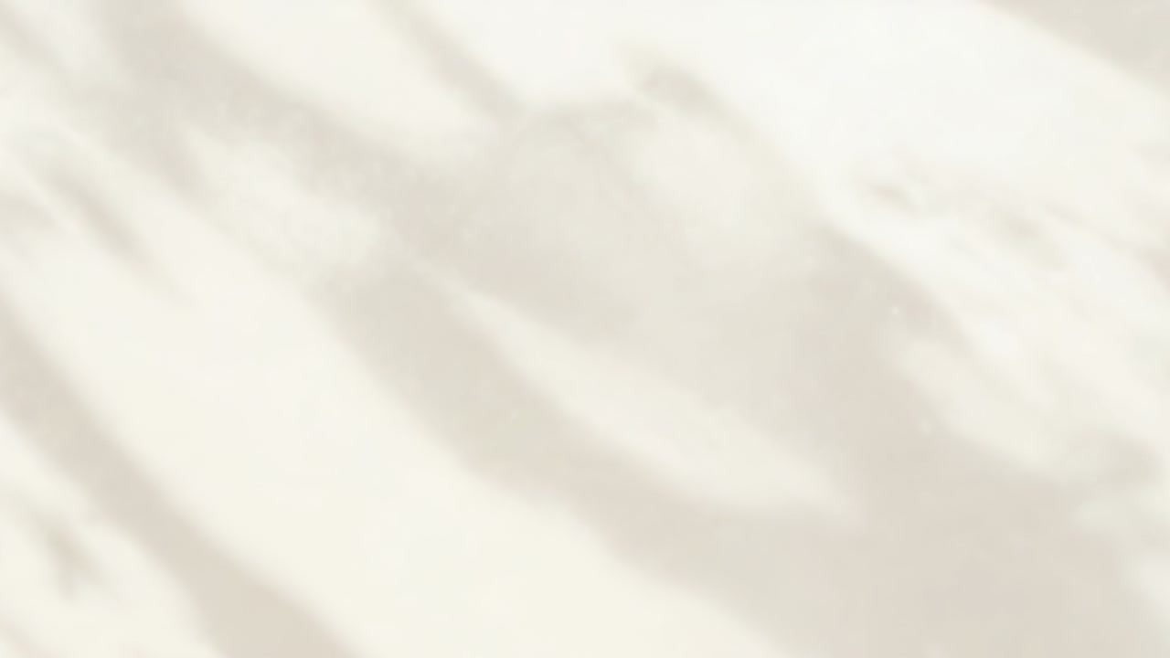 Shifting dappled shadows drifting across pale beige wall, sunlight shifting through foliage