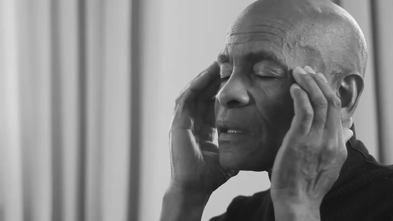 Elderly man suffering from a severe headache