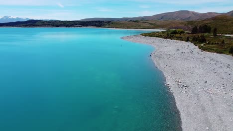 Serenity-unfolds:-Paddle-boarder-on-lake-with-hills-behind-in-captivating-stock-footage