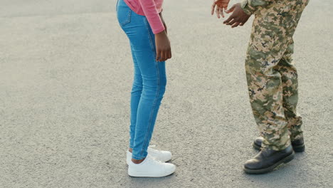 a soldier lifts his girlfriend