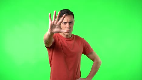 Man gesturing stop or looking serious on green screen