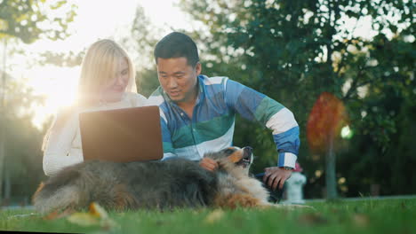 Couple-With-a-Dog-Using-a-Laptop
