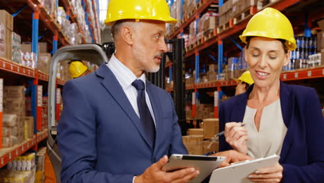 manager working with tablet and clipboard