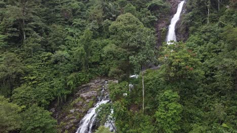 drone video of an untouched waterfall in the deep jungle of sumatra - indonesia