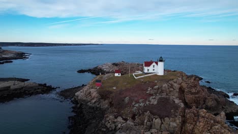 tilting angled view of lighthouse on a rocky island on the coast of southern maine in the atlantic ocean