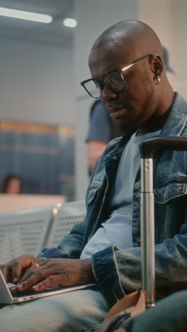 man working on laptop at airport